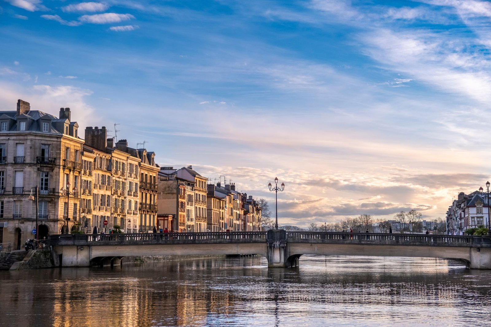 Rue calme de Bayonne avec façades traditionnelles à colombages, lumière du soir