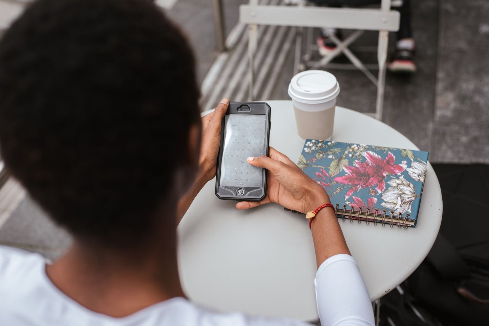 Personne rédigeant un message depuis un café à Orléans, illustration de l'étiquette de réservation respectueuse
